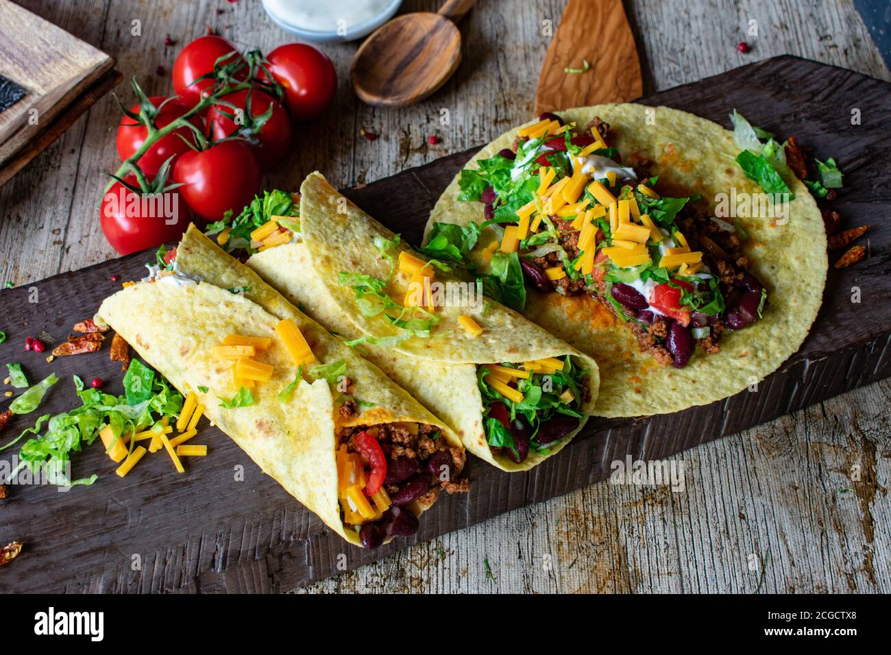 mexican spicy tortilla wraps with minced meat, kidney beans and