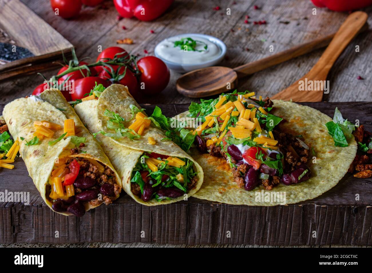 mexican spicy tortilla wraps with minced meat, kidney beans and