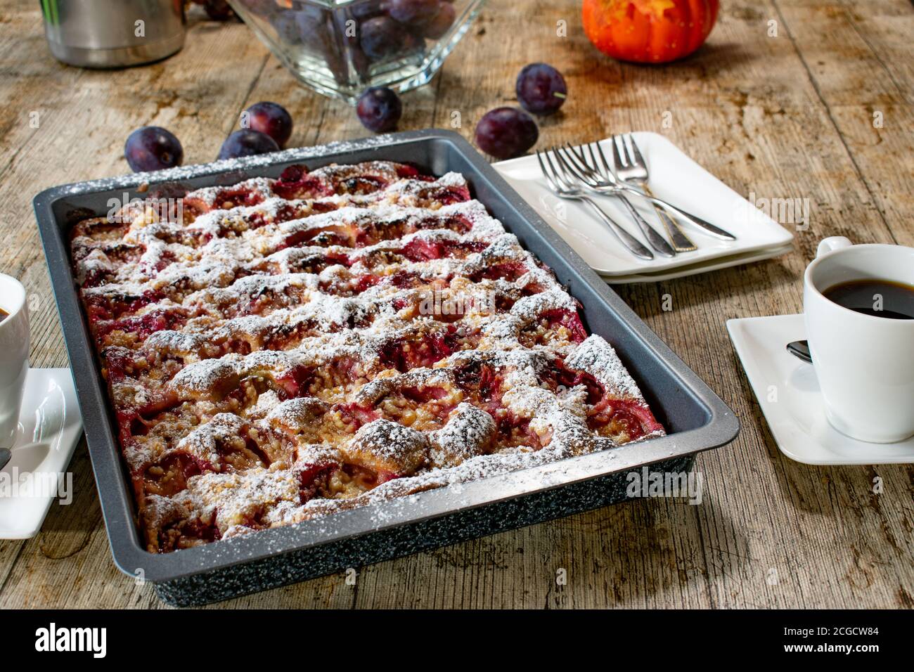fresh baked plum crumble cake on a table Stock Photo