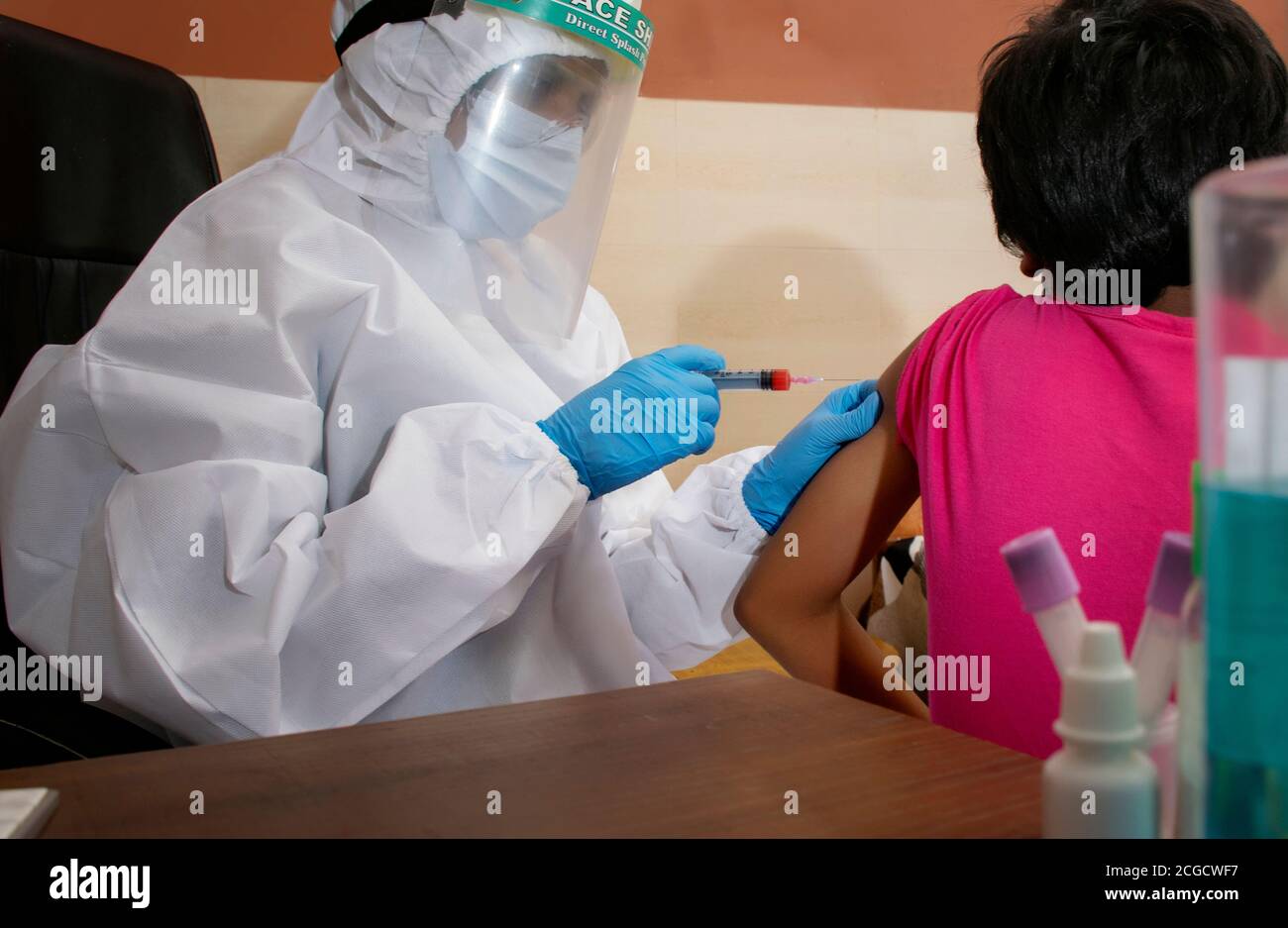 Doctor giving vaccine child holding hi-res stock photography and images ...