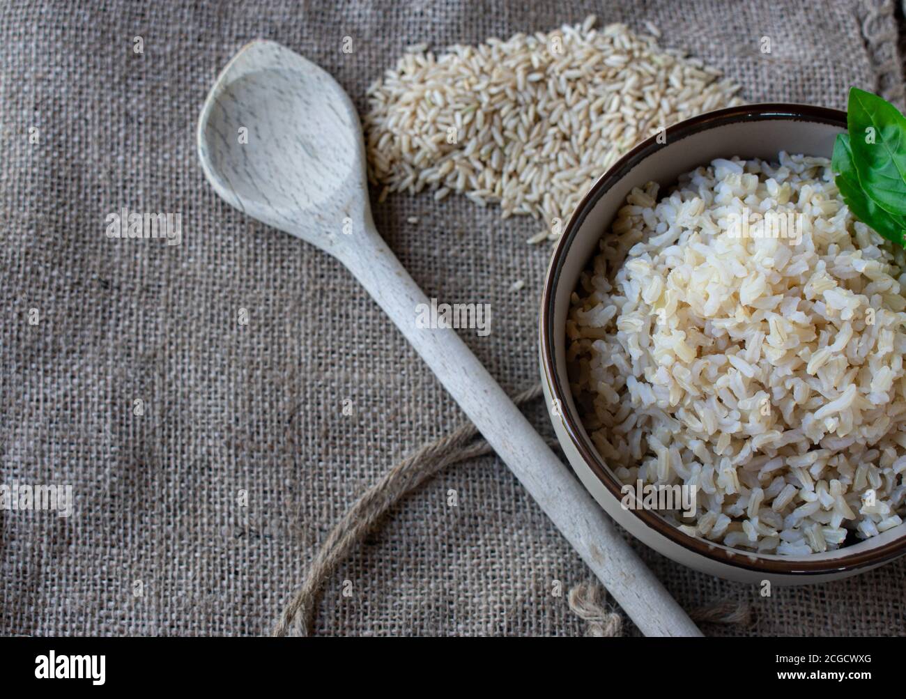 cooked and uncooked brown rice Stock Photo Alamy