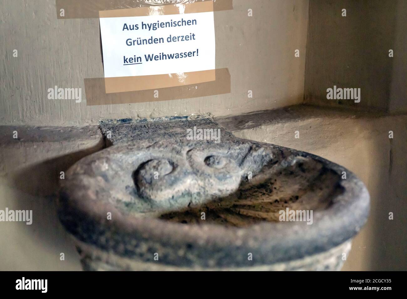 Germany, 9th. Sept. 2020: Due to the Corona crisis, sanctified water is not used in the holy water fonts in Catholic churches for hygienic reasons. Basin in the collegiate church of St. Martin and St. Severus in Münstermaifeld, Germany Stock Photo