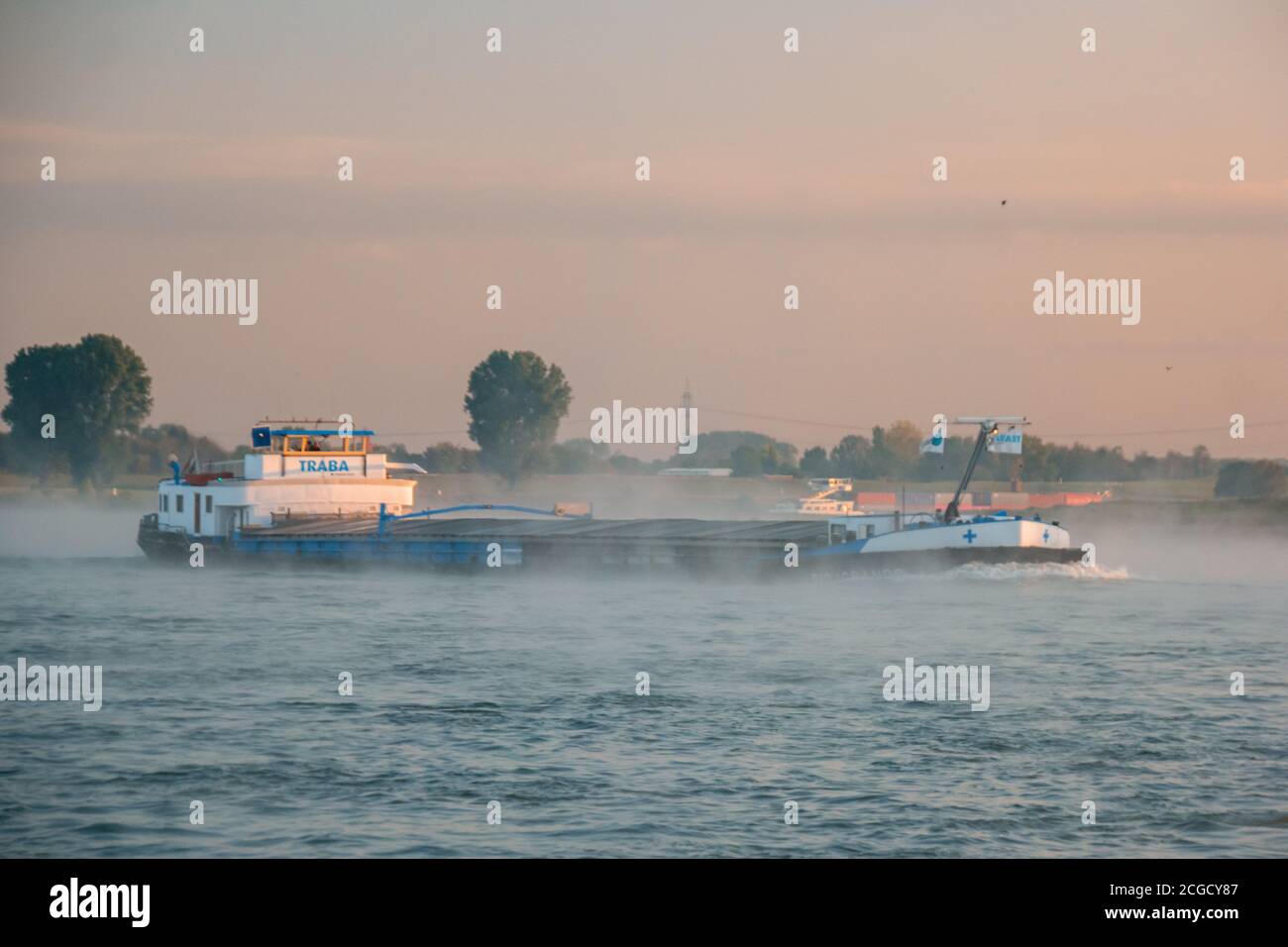 Cologne Germany August 2020, Inland shipping transport on the rhine river with containers, Large container and oiltanker vessel on the river rhein in Stock Photo