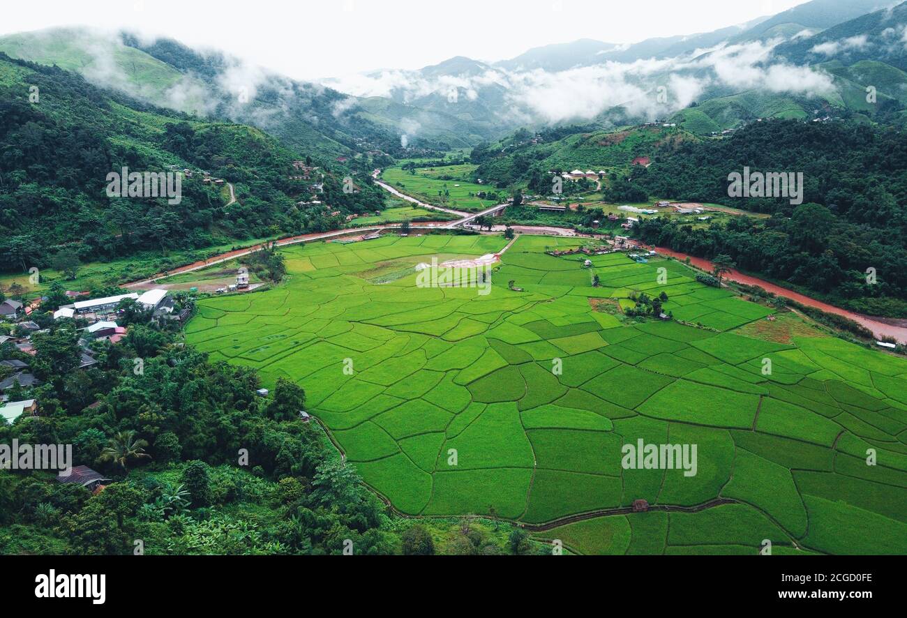 The village is surrounded by mountains and green rice fields Stock ...