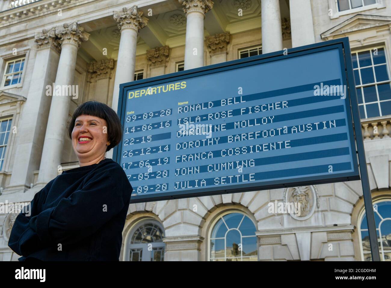 London, UK.  10 September 2020. Davina Drummond, of Yara and Davina, poses in front of their work Arrivals + Departures, a major interactive installation in the courtyard of Somerset House.  The artwork allows the public to memorialise their names on the mechanical flipboards which are often seen at a railway station or airport and is on show until 10 October 2020. Credit: Stephen Chung / Alamy Live News Stock Photo