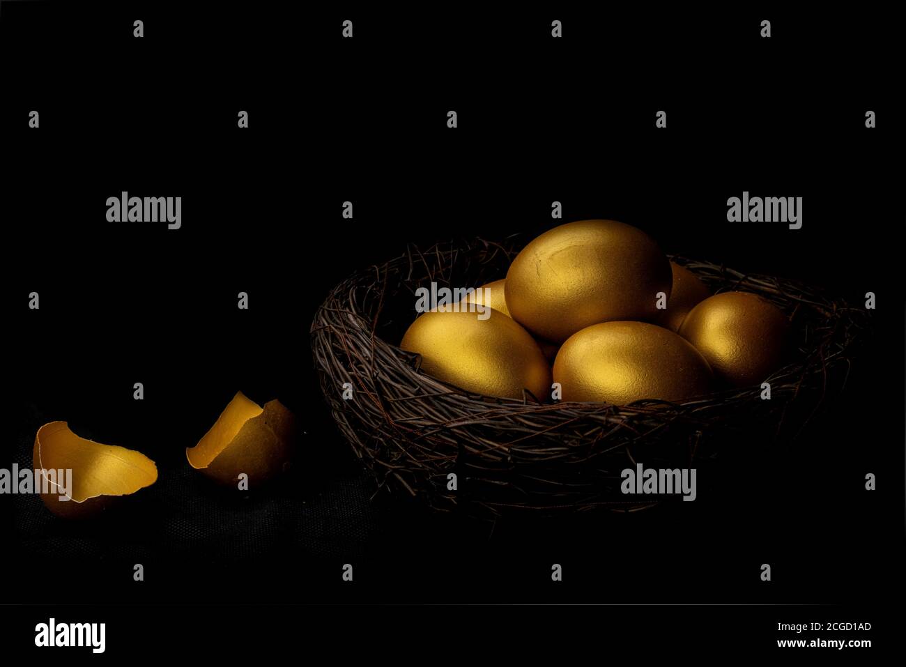 Golden egg and eggshell in nest isolated at black background Stock ...