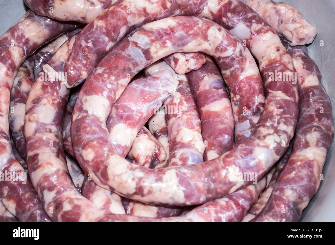 Making homemade sausage at home. Stuffing pork intestine with meat and