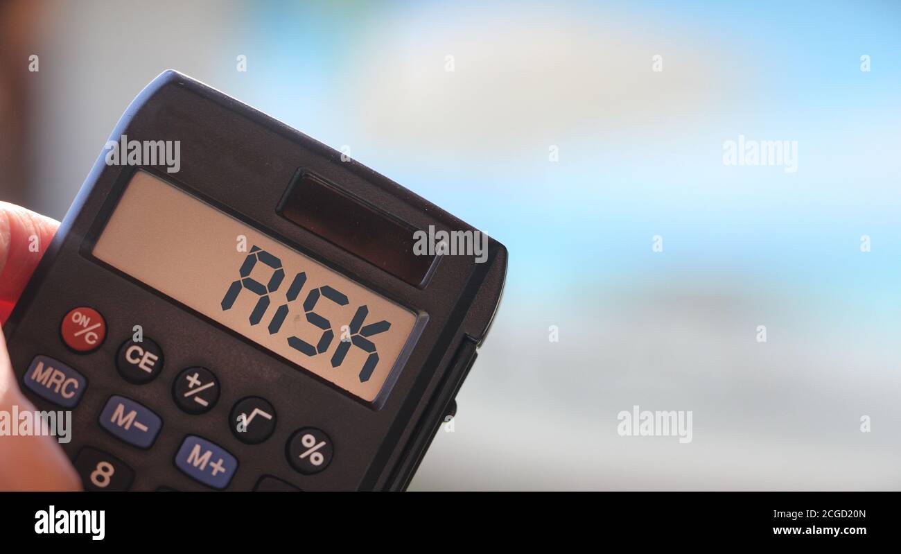 Calculator with the word risk on the display. Investment business concept Stock Photo