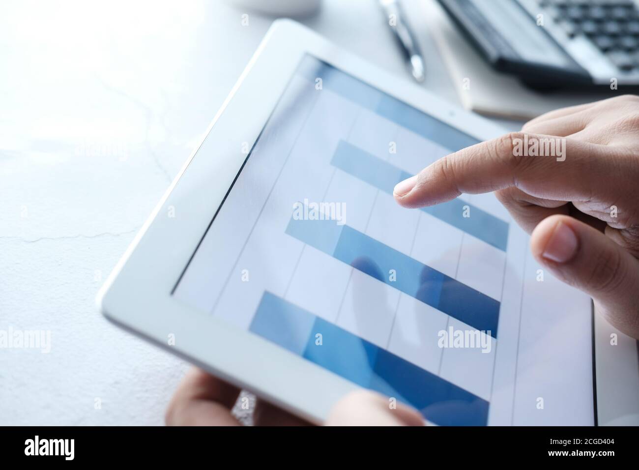 man's hand working on digital tablet at office desk, using self created ...