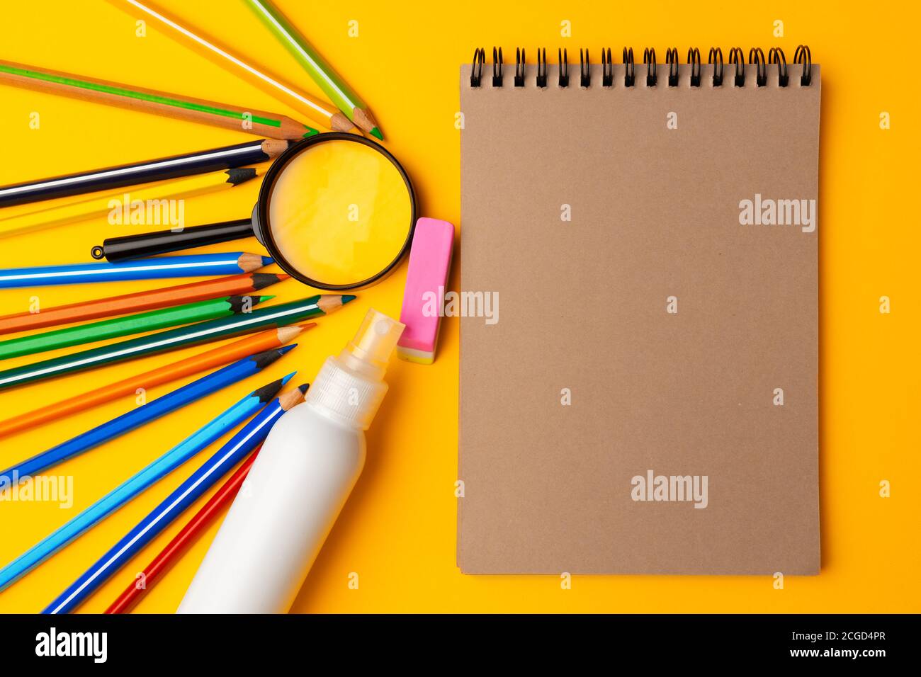 Notepad and color pencils on working space top view Stock Photo - Alamy