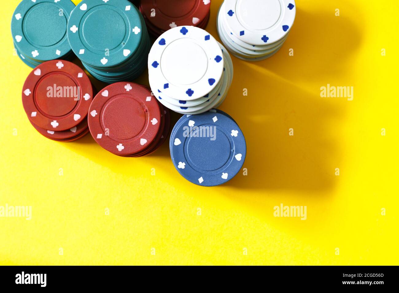 poker chips on yellow background Stock Photo
