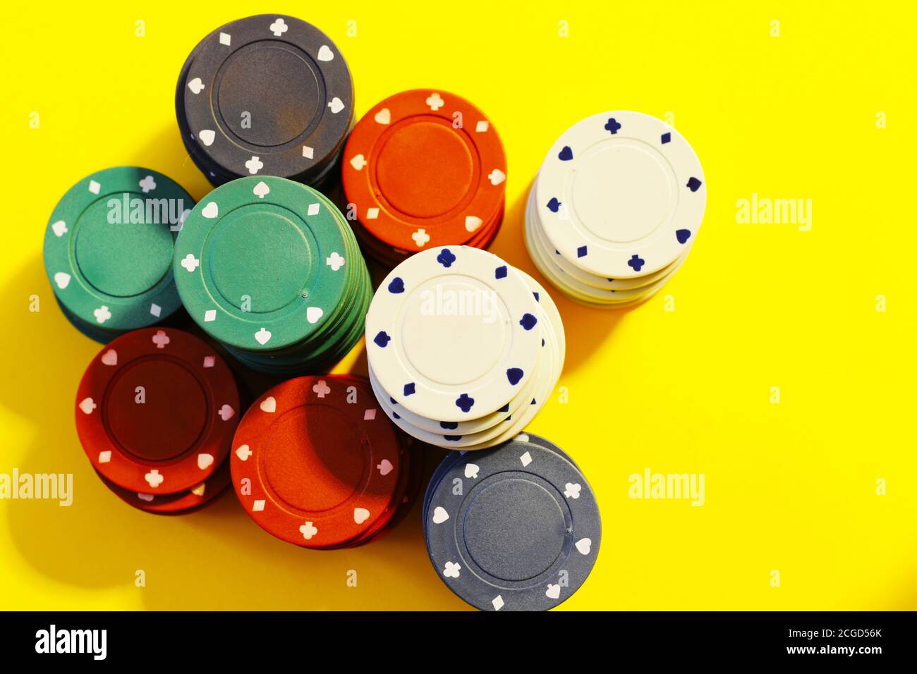 poker chips on yellow background Stock Photo
