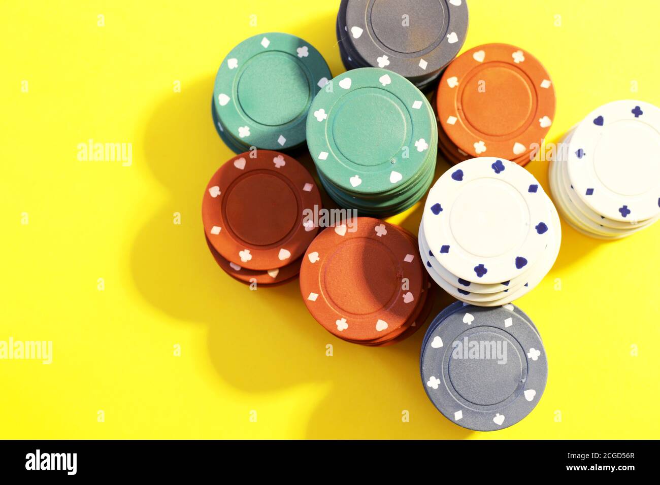 poker chips on yellow background Stock Photo