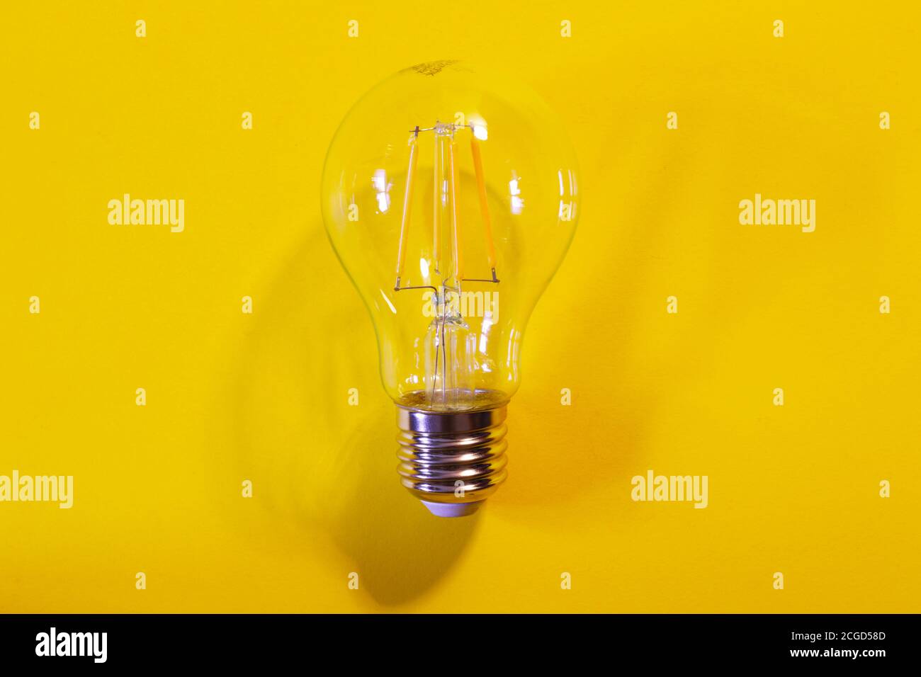 light bulb on yellow background Stock Photo - Alamy