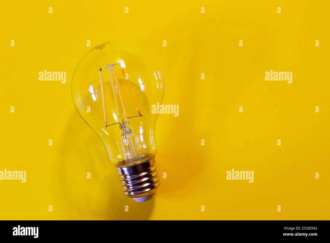 light bulb on yellow background Stock Photo - Alamy