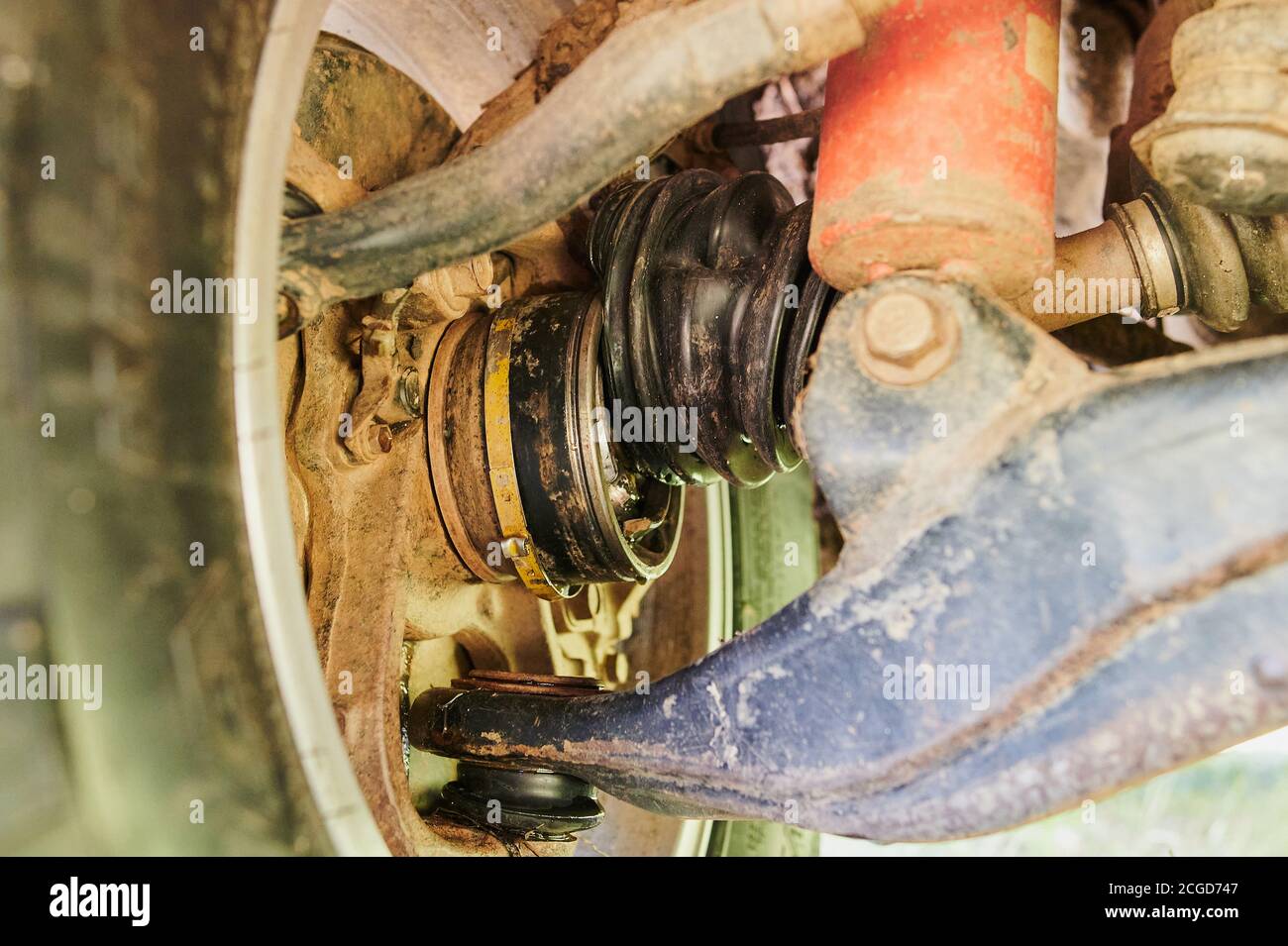 Old damaged CV joint duster close up fallen into the mud on the road