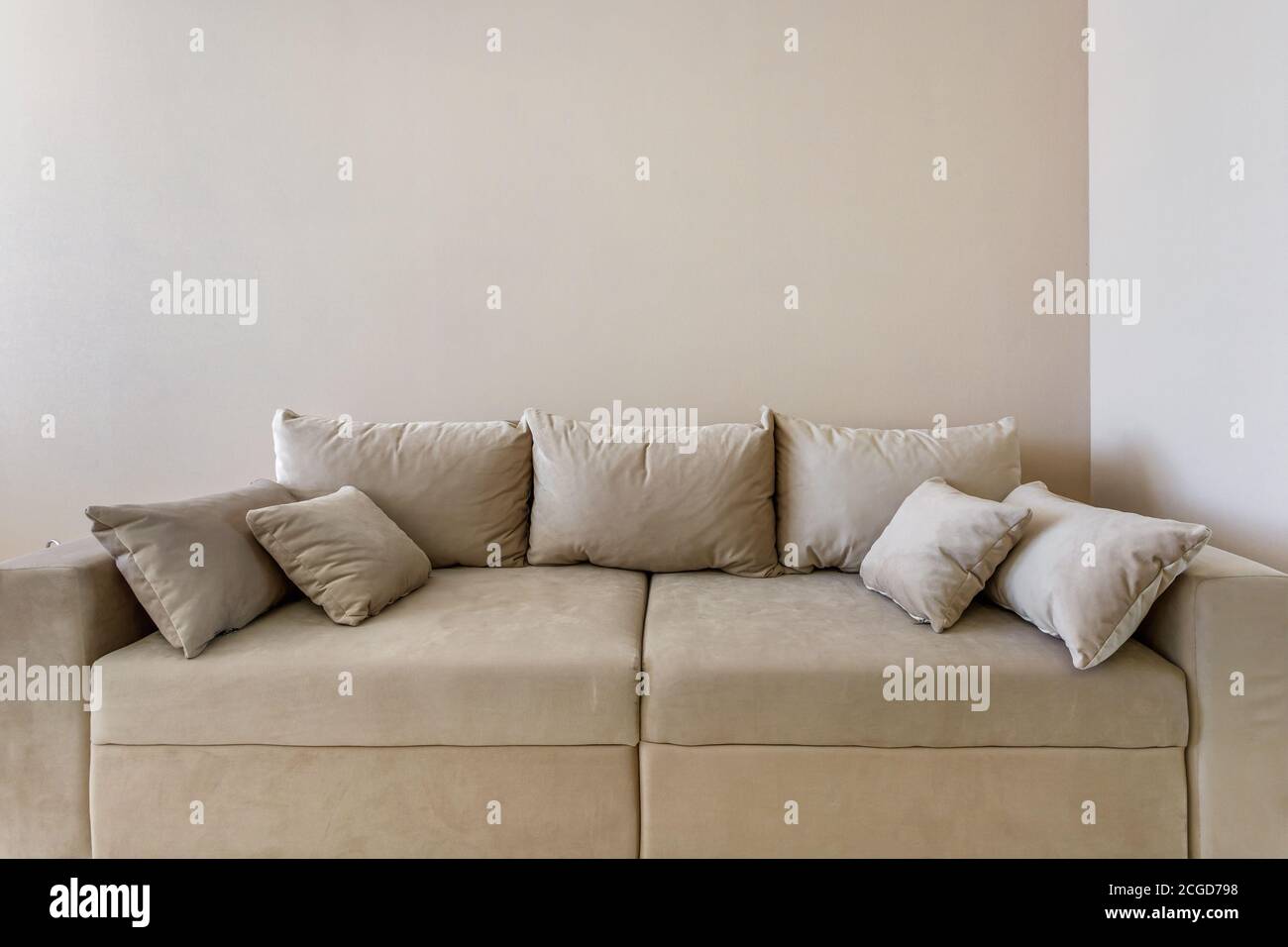 fabric sofa with pillows in Interior of modern guestroom in studio apartments Stock Photo
