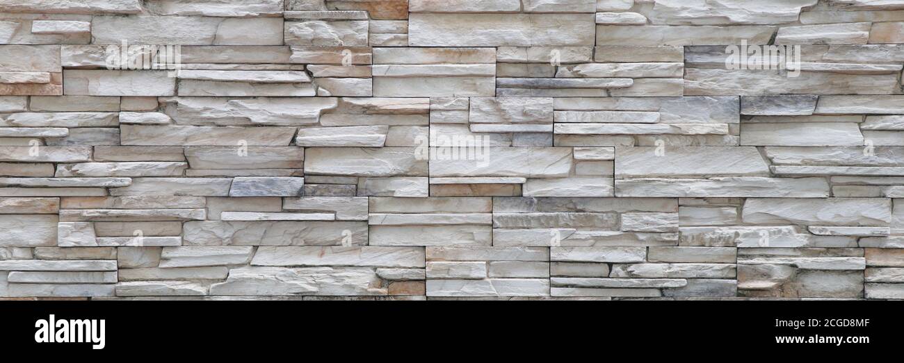 Stone background walls are stacked. Stone cladding background and wallpaper. Stock Photo