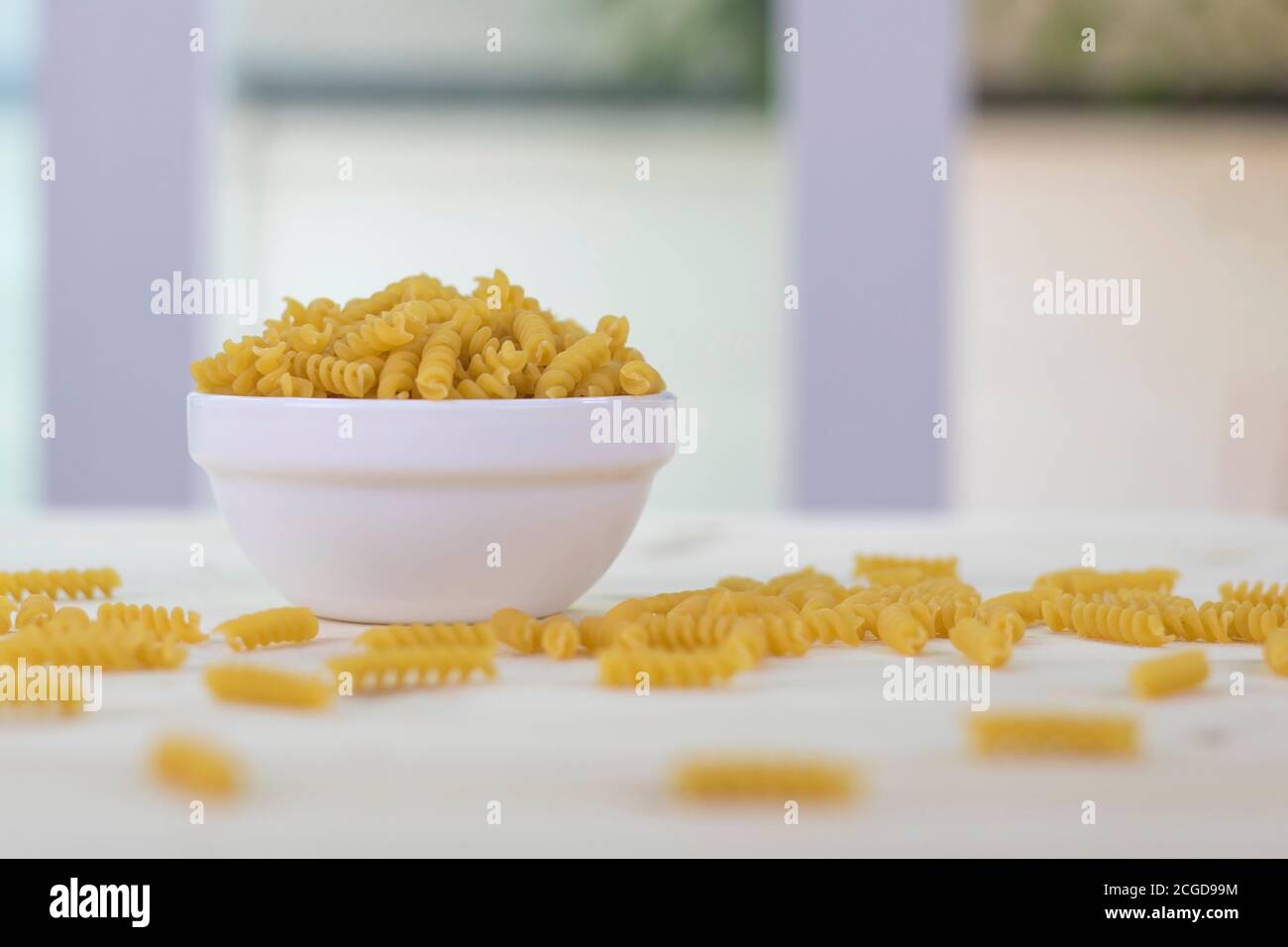 Fusilli in white cups placed on a wooden table. Stock Photo
