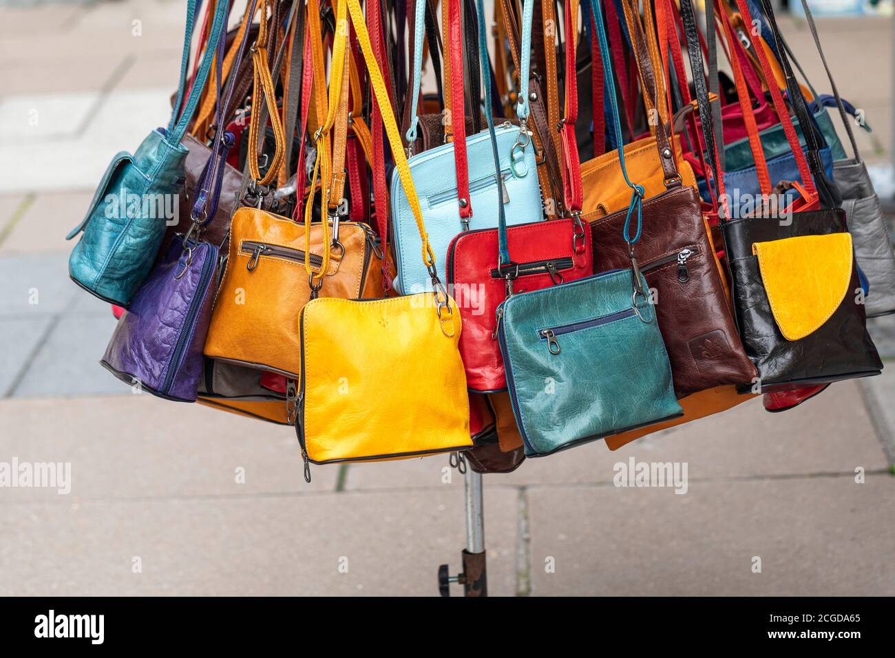 Bright colourful leather handbags for sale on a market traders stall in the  City of Bath, England, UK Stock Photo - Alamy