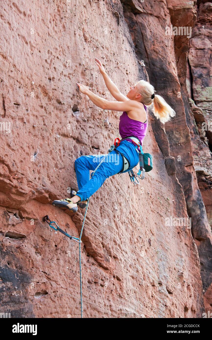 Young blonde woman climbing an extreme diffcult rock - Veronika Frank at Rötzenstein - Pfalz Stock Photo