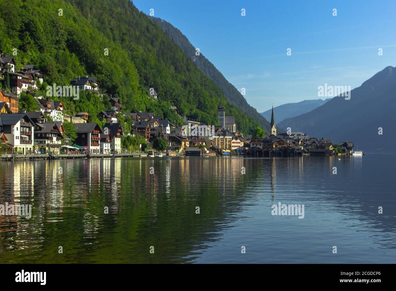 Classic postcard view of famous Hallstatt lakeside town, Austria. Scenic panoramic view of beautiful town reflecting in Hallstatter See. Stock Photo