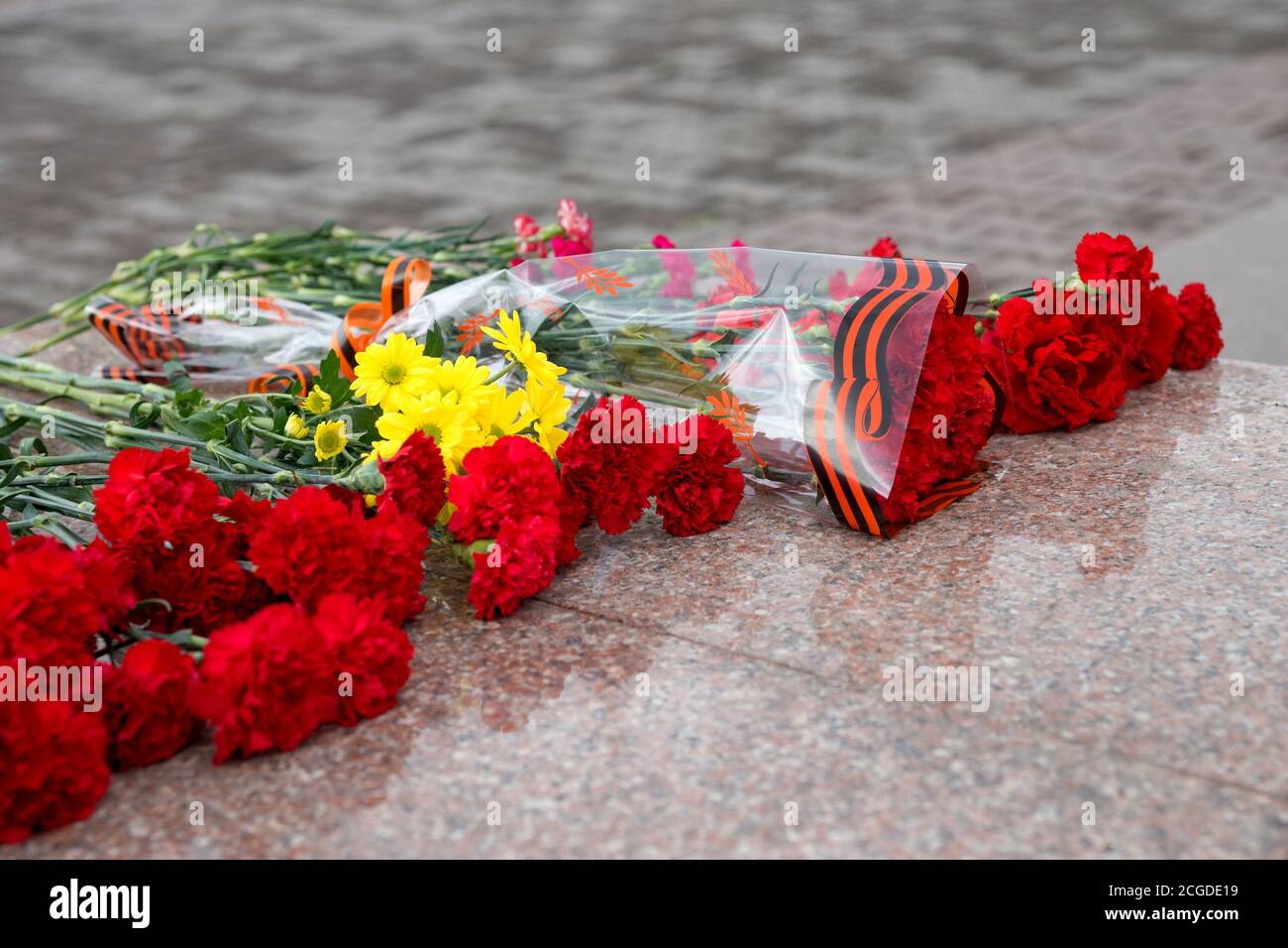 Bouquets of flowers lie on granite in the Victory Memorial during the ...