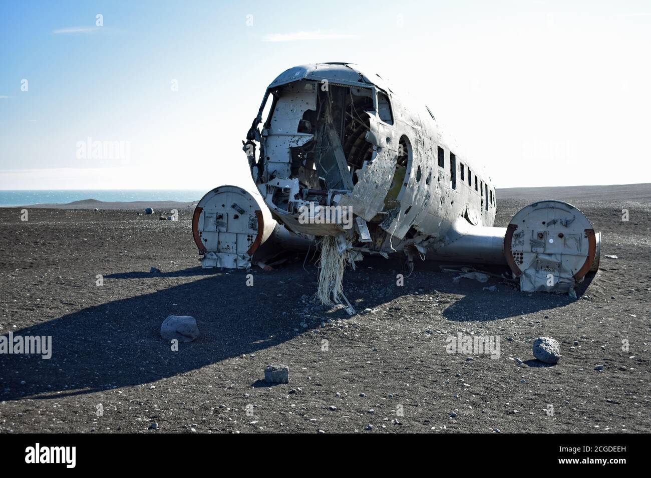 Looking at the front of the Solheimasandur Plane Wreck on the black sand.  The two engines are still in place.  A bright sunny day.  Iceland. Stock Photo