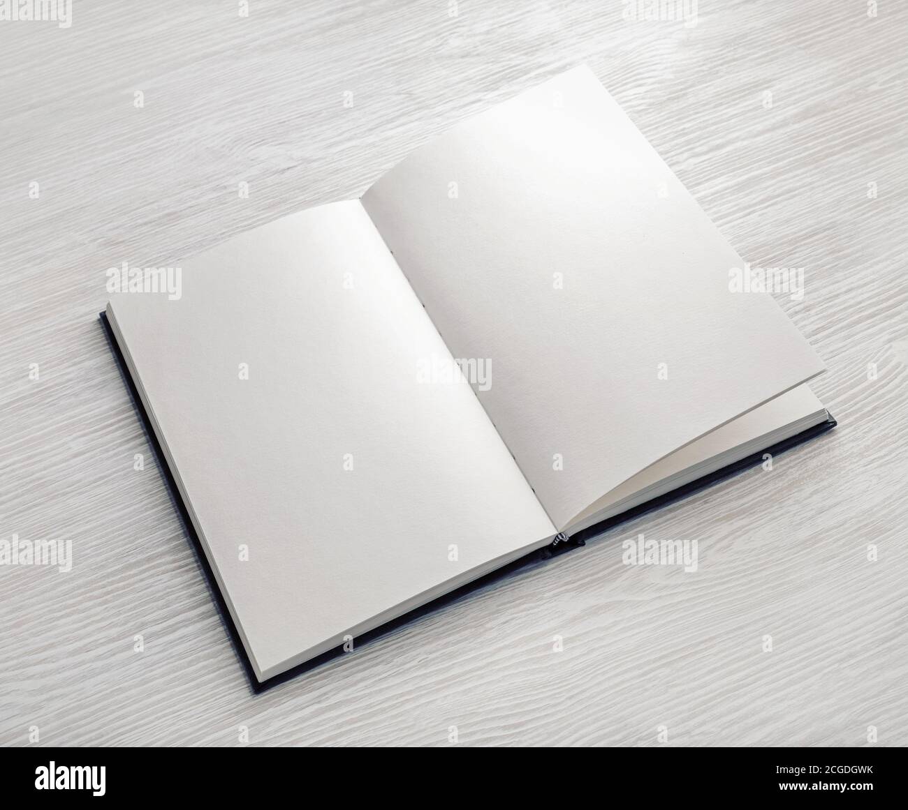 Mockup of opened blank booklet on light wooden background. Stock Photo