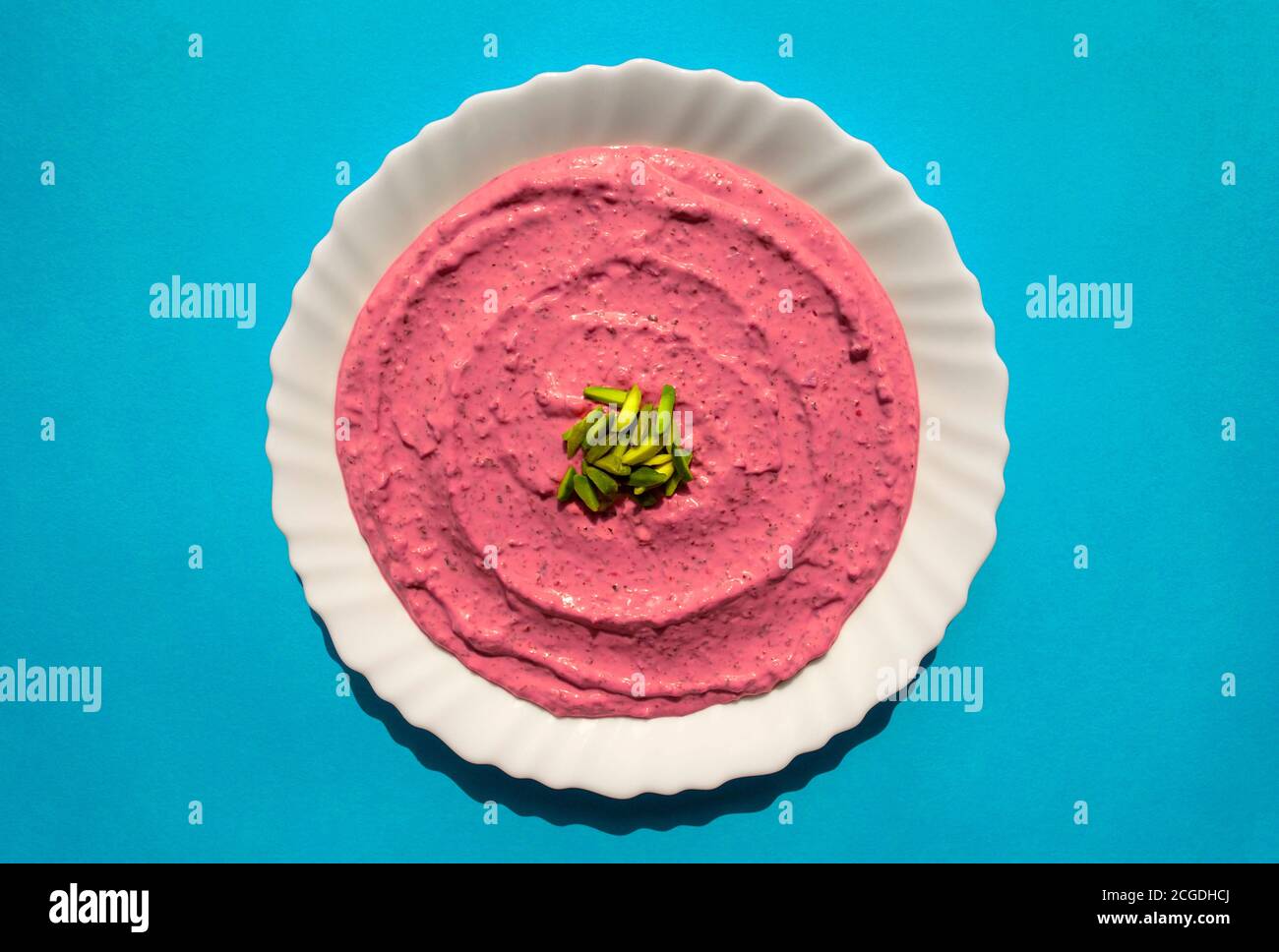 Famous traditional Arabic cuisine Beet hummus in a white plate on