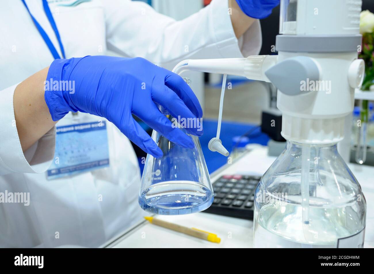 Lab assistant hands working with titrator to measure quality of water Stock Photo