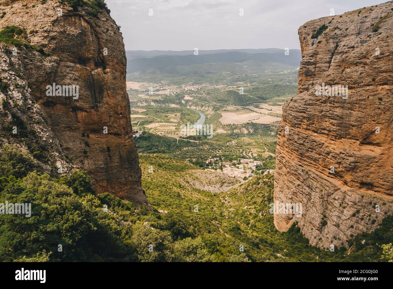 Riglos Village beneath the conglomerate rock formations of the Mallos de Riglos, Huesca, Aragon, Spain. About 300 meters below the viewpoint, located Stock Photo