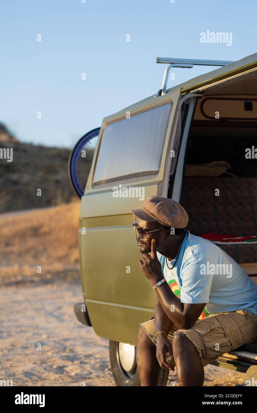 black african american man sitting in his camper van thoughtfully Stock Photo