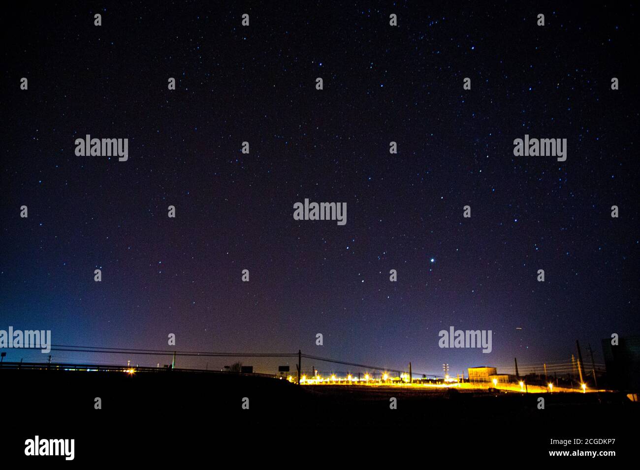 Starry sky over avenue and transformed from high intensity light Stock Photo