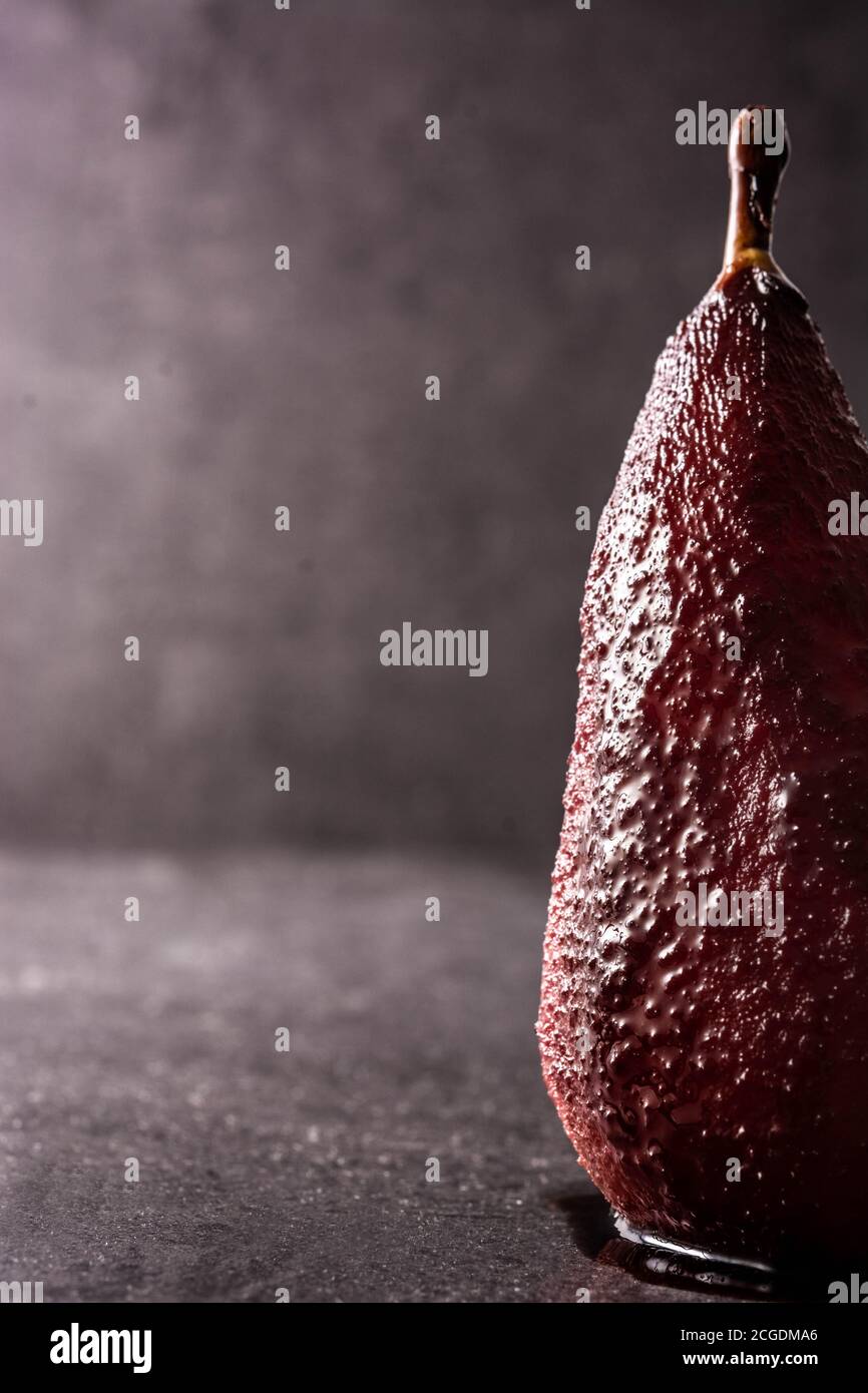 Poached pears in red wine on black background Stock Photo