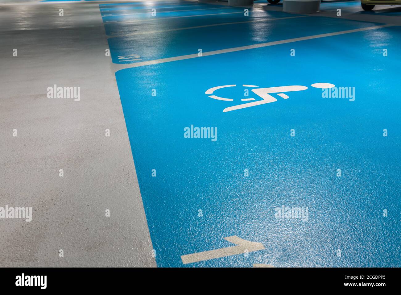 Disabled parking sign in a public parking garage in blue Stock Photo