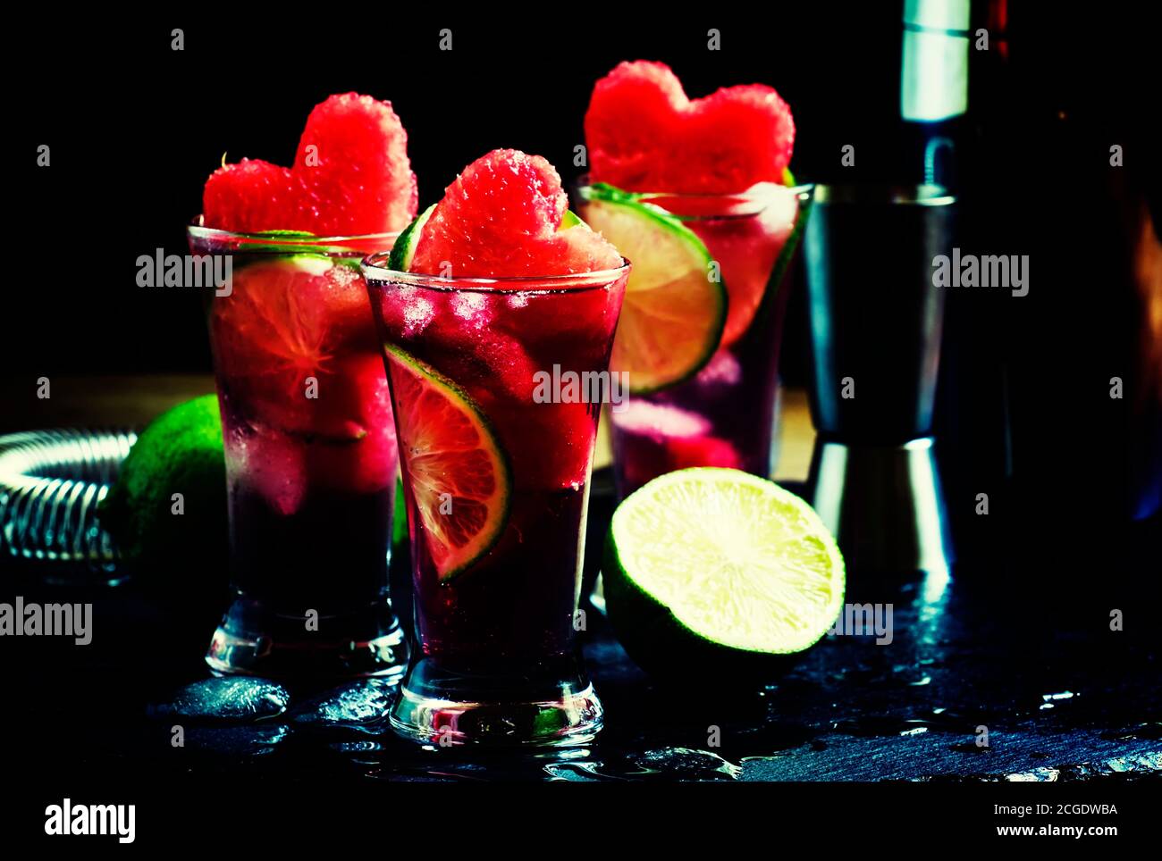 Alcoholic cocktail pasteque with vodka, watermelon juice, lime and ice. Bar tools on dark background, selective focus Stock Photo