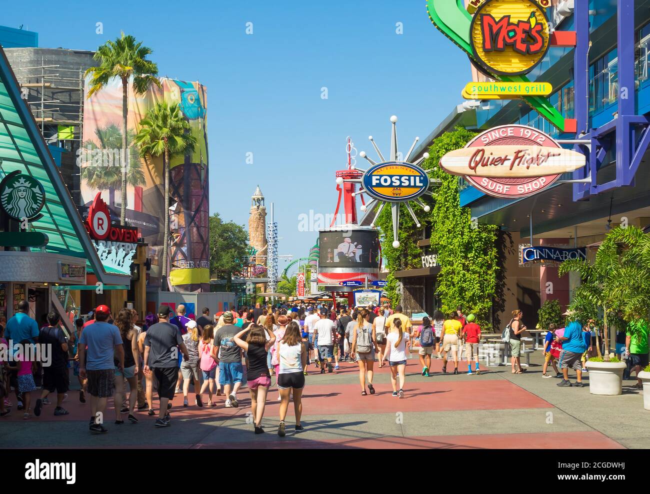A crowd of visitors walking towards the entrance of the Universal Orlando Resort theme parks in