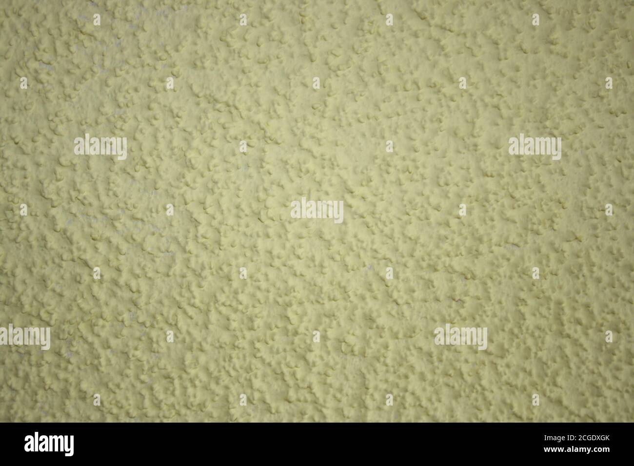 Close-up of yellow painted wall. Background, texture. Stock Photo