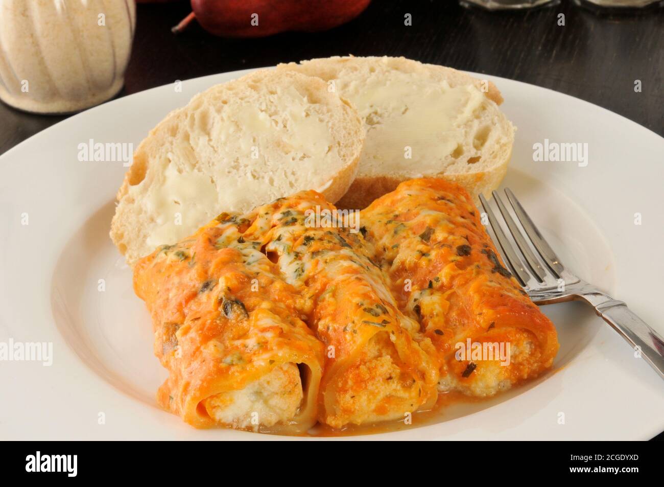 Four cheese manicotti with tomato vodka sauce and buttered bread Stock