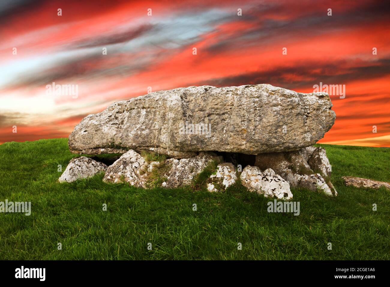 Lligwy Cromlech is a Neolithic burial chamber in Anglesey, Wales. Excavation found remains of up to 30 people. The sky and skyline has been changed. Stock Photo