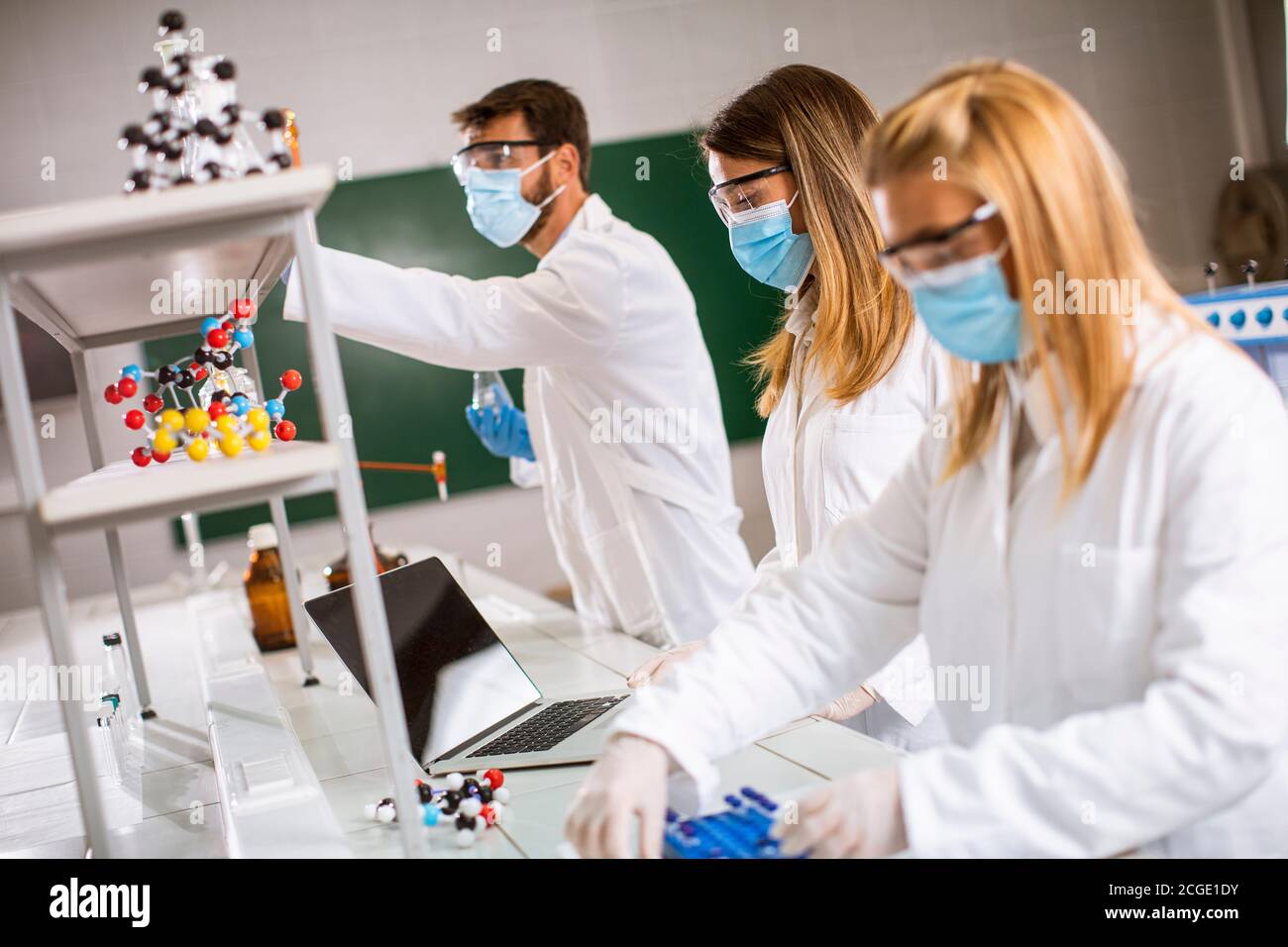 Young researchers analyzing chemical data in the laboratory Stock Photo