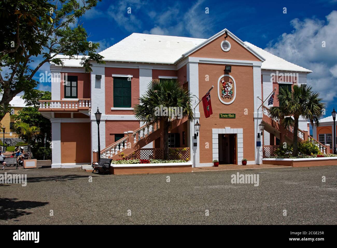 Town Hall, tan, white, flag, 1782, double outside stairs, crest; government building, palm trees, flowers; St. George; Bermuda Stock Photo