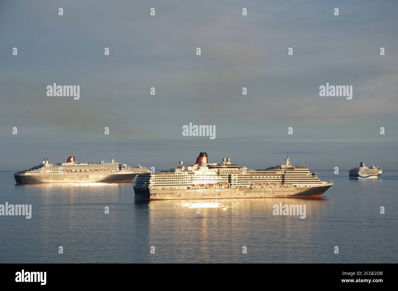 Cruise ships: Queen Victoria, Queen Mary 2, Marella Explorer and Marella Discovery anchored in Weymouth Bay. Mothballed during the Covid-19 pandemic. Stock Photo