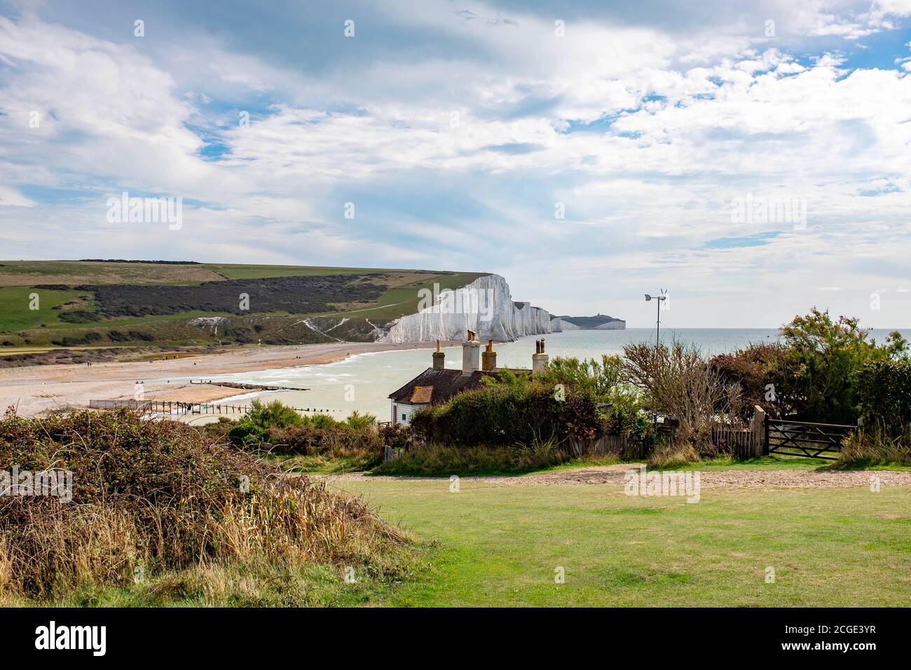 The famous coastguard cottages on the cliffs overlooking Cuckmere Haven at Seaford Head Nature Reserve . The cottages are in danger because of erosion Stock Photo