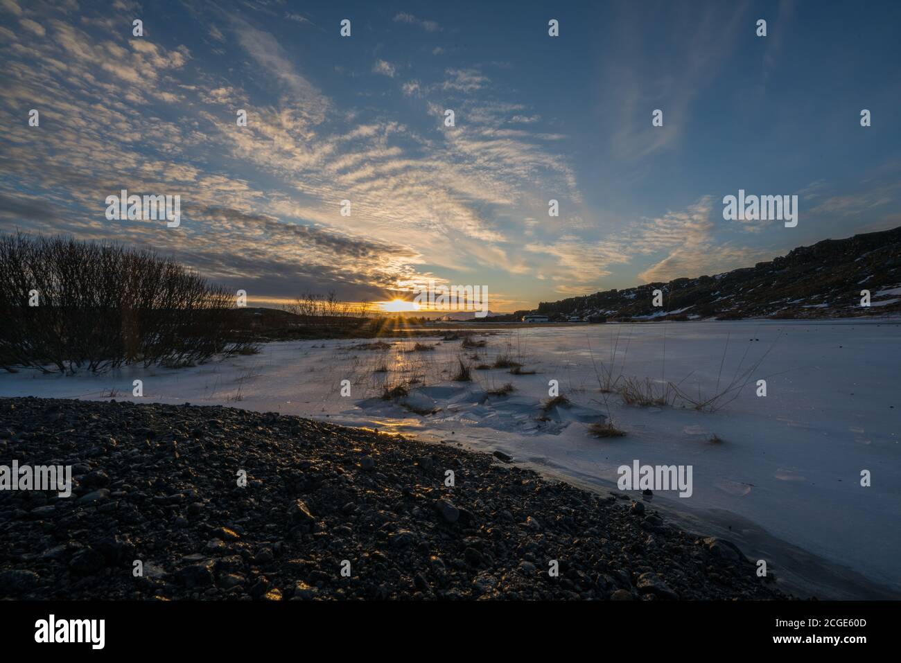 Frozen  shallow lake in Þingvellir National Park at Sunset Stock Photo