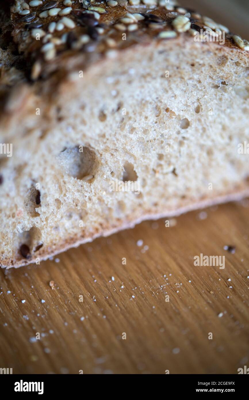 Freshly baked seeded loaf on a bread board Stock Photo