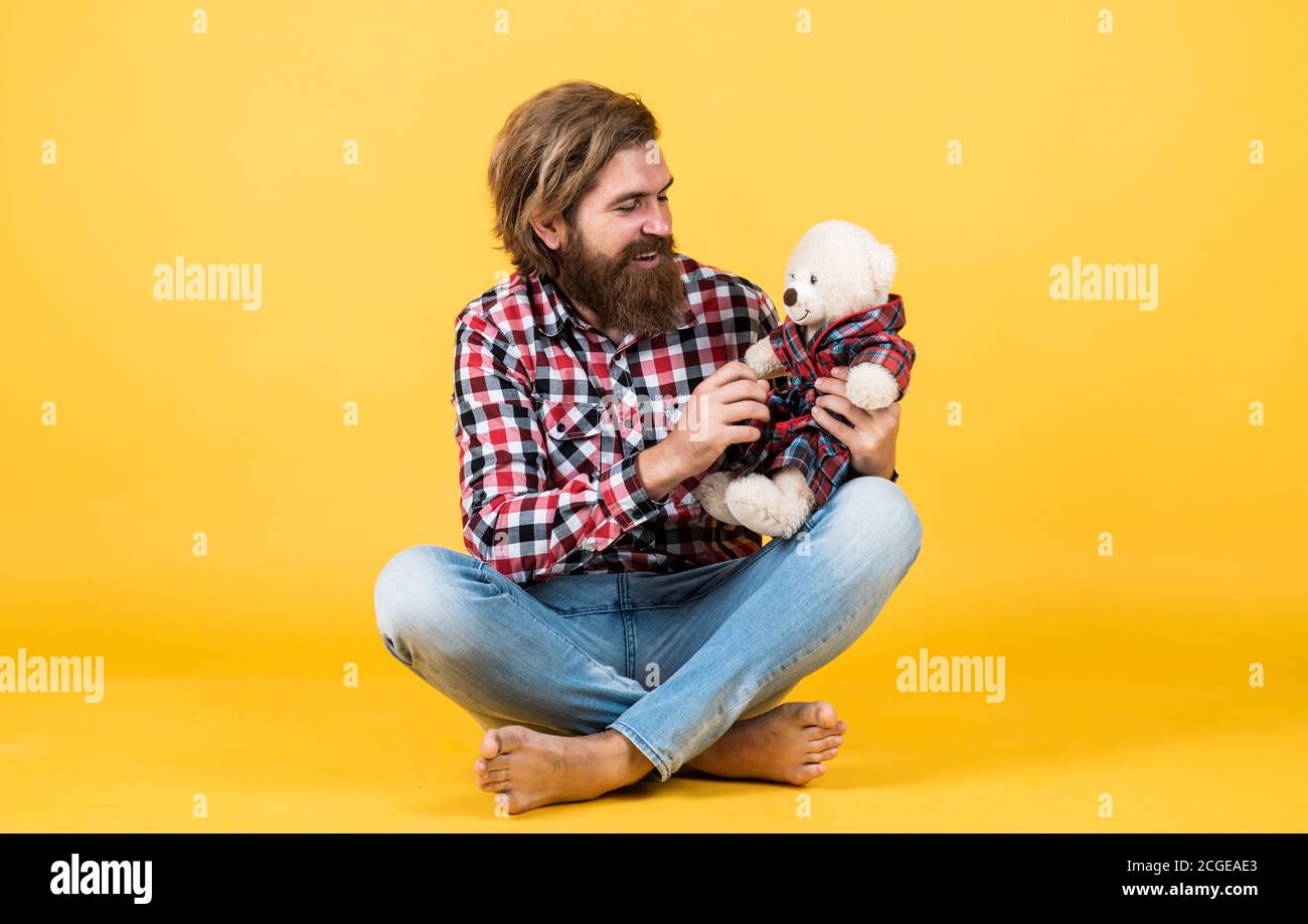 friendship. brutal mature hipster man play with toy. happy birthday. being in good mood. happy valentines day. cheerful bearded man hold teddy bear. male feel playful with bear. Stock Photo