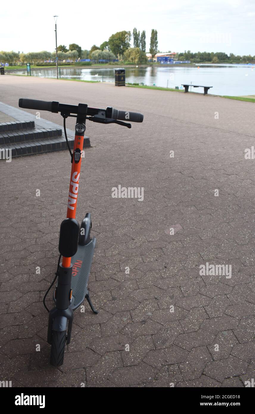 Spin e-Scooter at Willen Lake with copy space on the right-hand side. Stock Photo