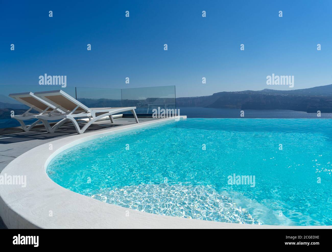 Lounge chair and pool over Santorini caldera. Akrotiri, Santorini